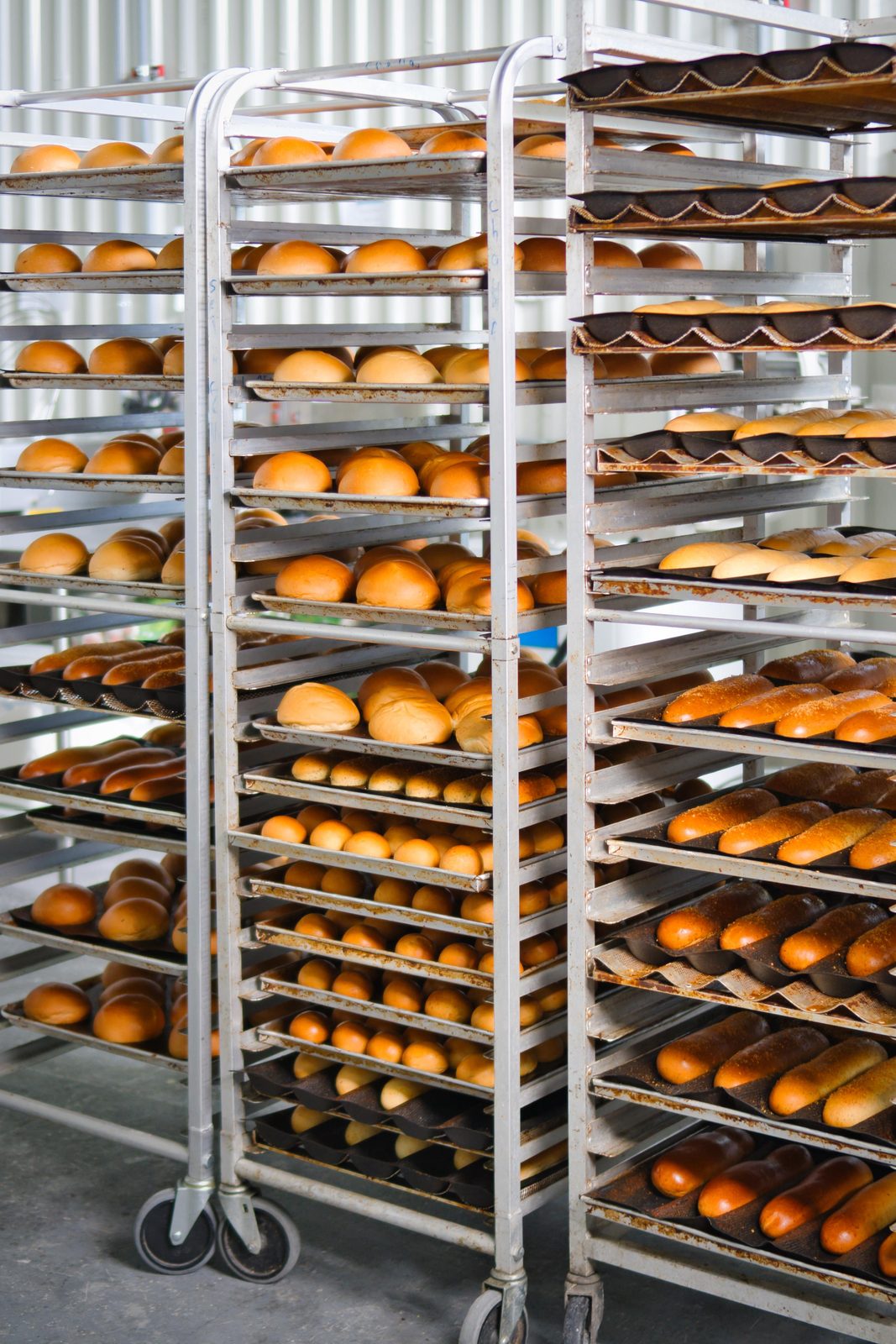 Racks rodantes con pan enfriándose en la fábrica